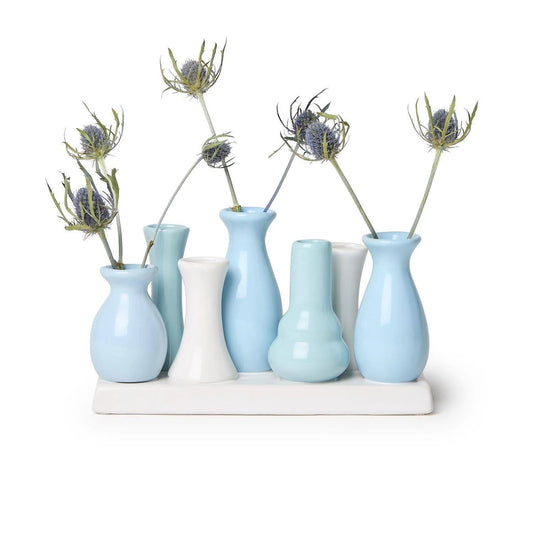 Two's Company Blue Hues Multi Vase with five blue and white ceramic vessels on white base holding dried thistle stems